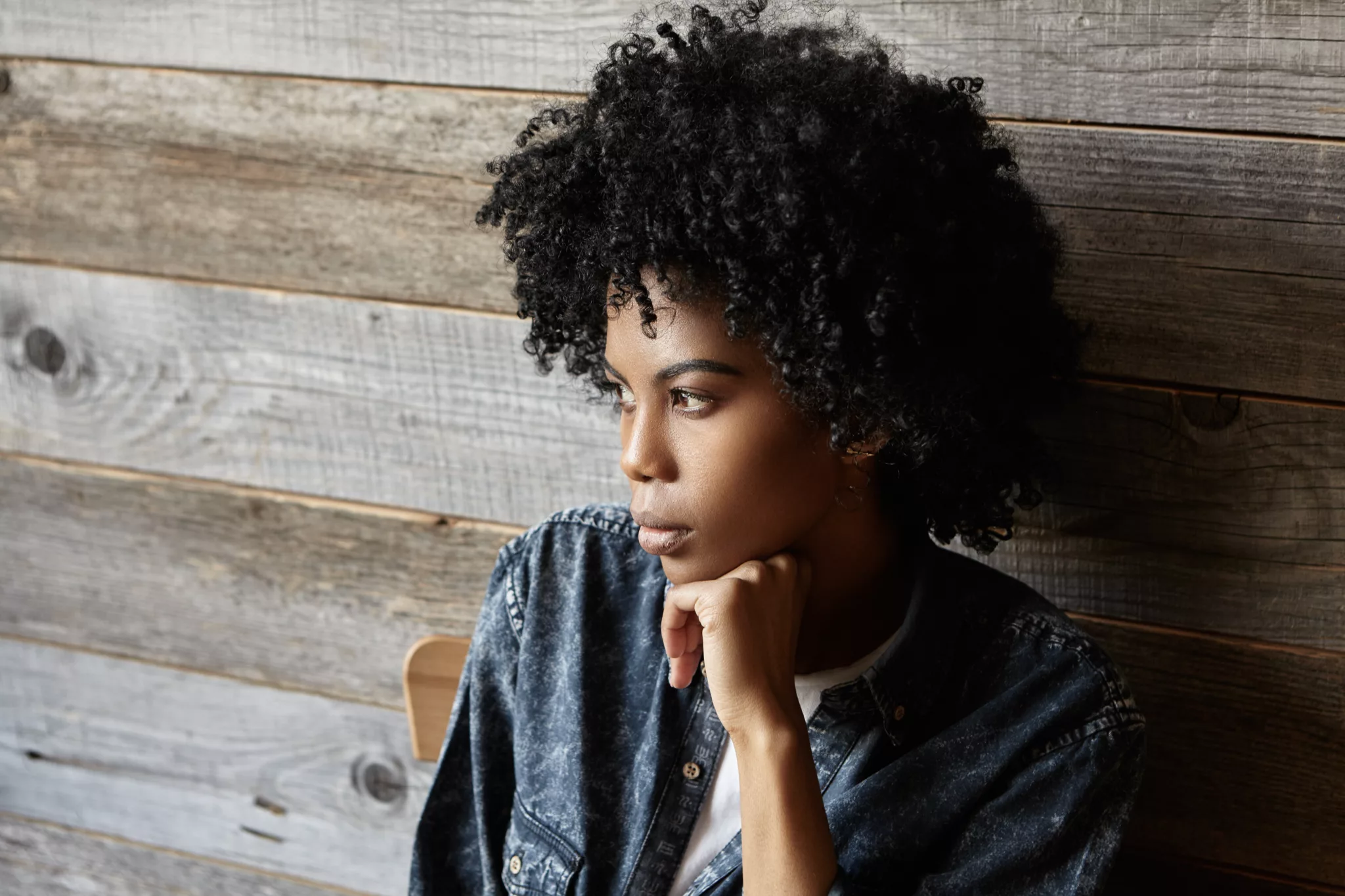 Portrait of fashionable young African American female dressed in denim shirt having serious and thoughtful look, thinking about something important, sitting at cafe with head reclined upon her hand;catastrophic thoughts scenario thinking worst case scenario if I lose my job. thinking worst case scenario before a job interview, what if my business fails? worst case scenario, worst case scenario if I quit my job, how to think through worst case scenarios, benefits of planning for the worst case, is thinking worst case scenario helpful?, how to stop catastrophizing about worst case scenarios, exercises for visualizing worst case scenarios, examples of worst case scenarios for common situations, how to manage anxiety after thinking worst case scenario, positive spin on thinking worst case scenario, when is it bad to think worst case scenario?, what are the dangers of always thinking worst case scenario? Twanna Carter;Unlocking the Mind: Overcoming the Worst-Case Scenario Mentality