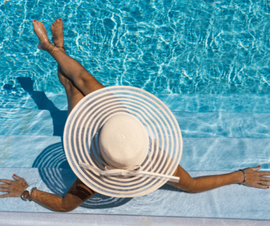 a woman wearing a hat and sitting in a pool; Work-life-balance-tips-_image-by-Netfalls