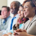 African American businesswoman attending seminar or job training business conference; Leverage Your Transferable Skills for a Career Transition – Learn How to Pivot Without Starting Over ; find Black executive coach near; best Black executive coach near; find Black career near; best Black career coach near 