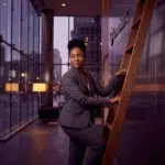 Black woman standing on a ladder; career clarity; executive coaching for Black women