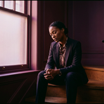 Black woman sitting steps; perfectionism at work