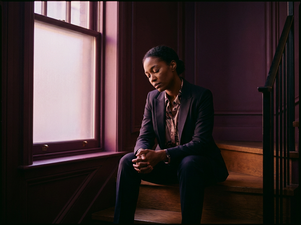 Black woman sitting steps; perfectionism at work
